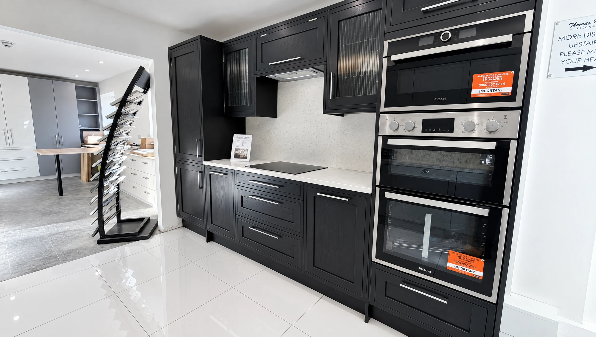 Black shaker kitchen with twin Hotpoint ovens on display at Thomas Howie Southport