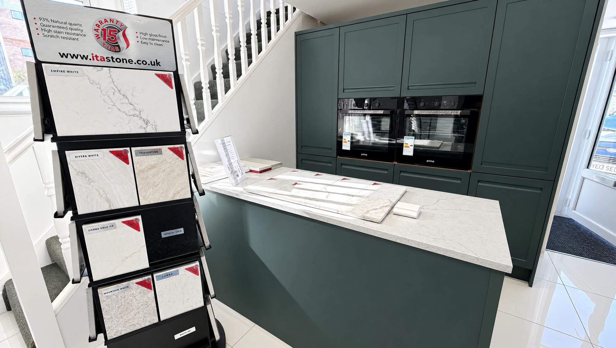 Deep green shaker kitchen with quartz worktop and twin ovens in the Southport showroom