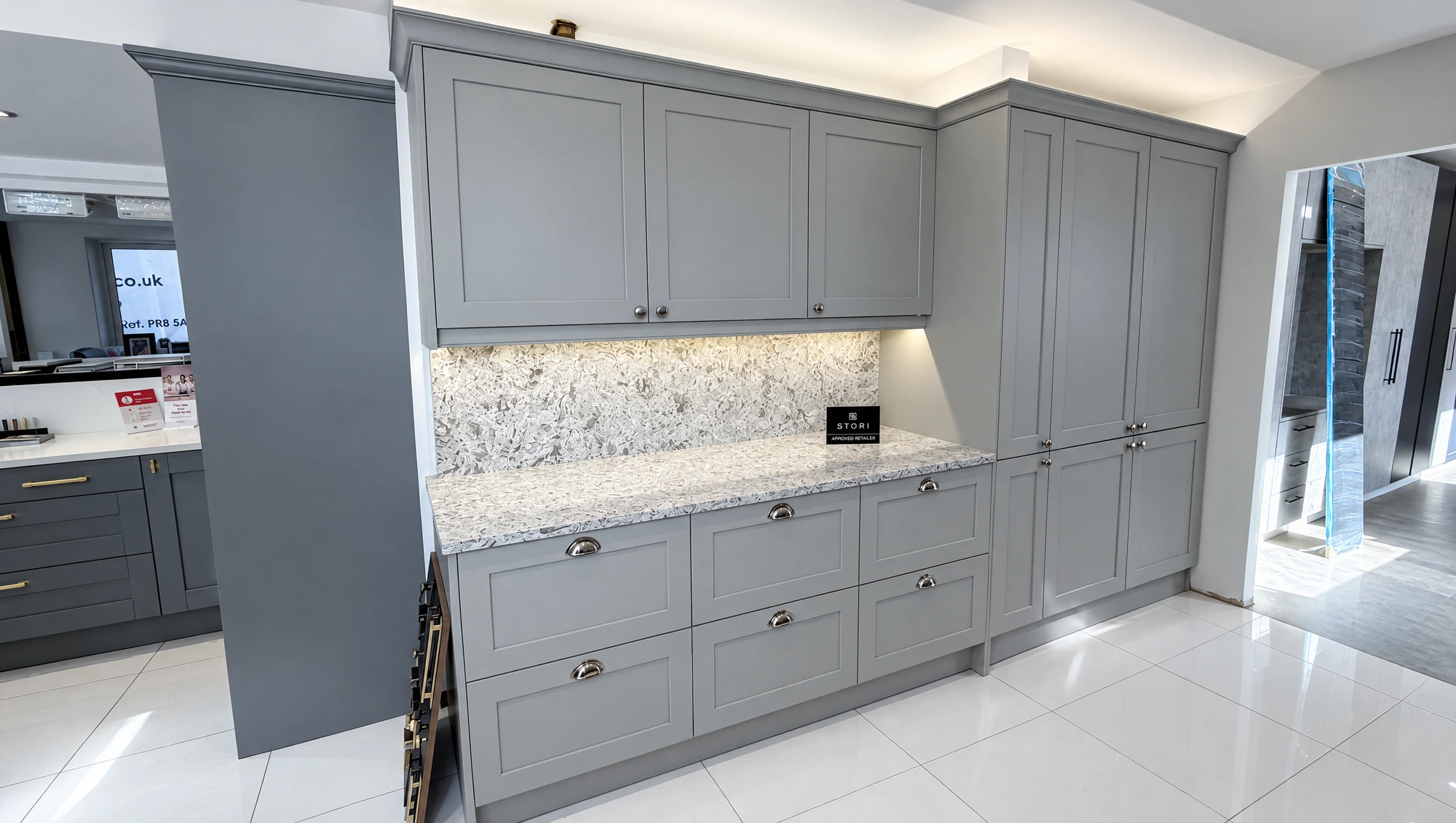 Grey shaker kitchen with marbled quartz splashback and worktop in the showroom